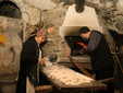 FORNAIO/BAKER: Laura Botto helps Alberto Bruno, the “fornaio”, to make the bread. Once ready, small slices of bread were offered to visitors. (Gianluca Avagnina Photography)